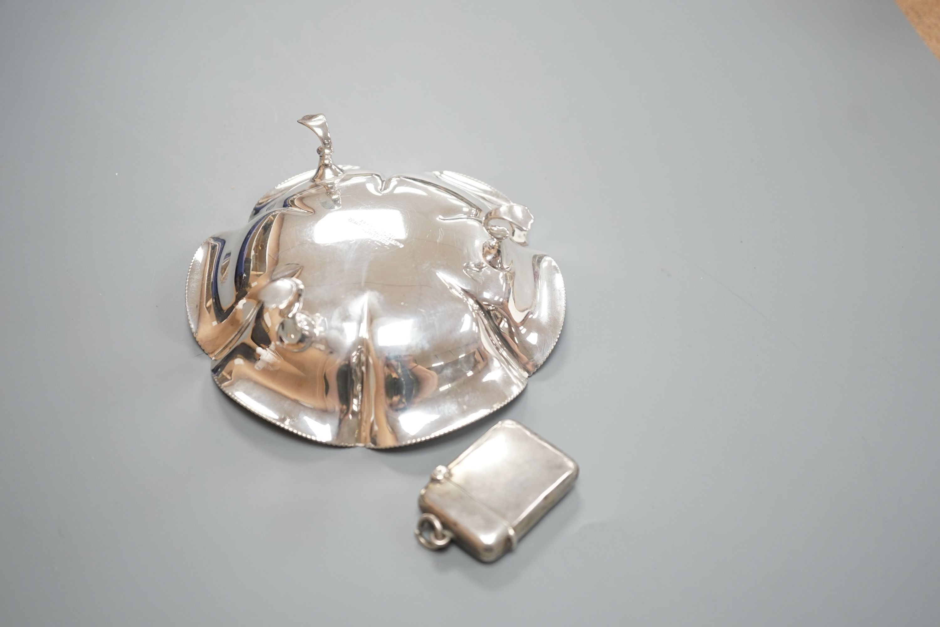 A late Victorian silver vesta case, Lucas & Co, Birmingham, 1898 and a later silver dish by Goldsmiths & Silversmiths Co Ltd, London, 1903.